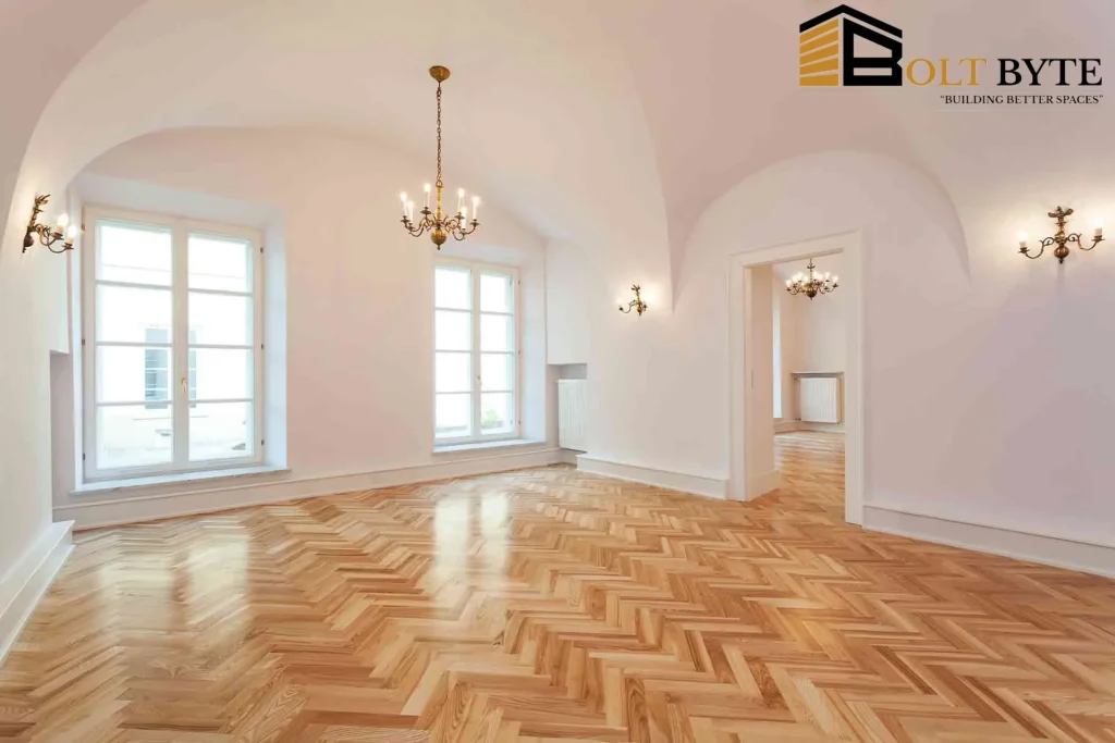Elegant Herringbone parquet flooring by Bolt Byte in a premium, high-ceiling room with chandeliers.