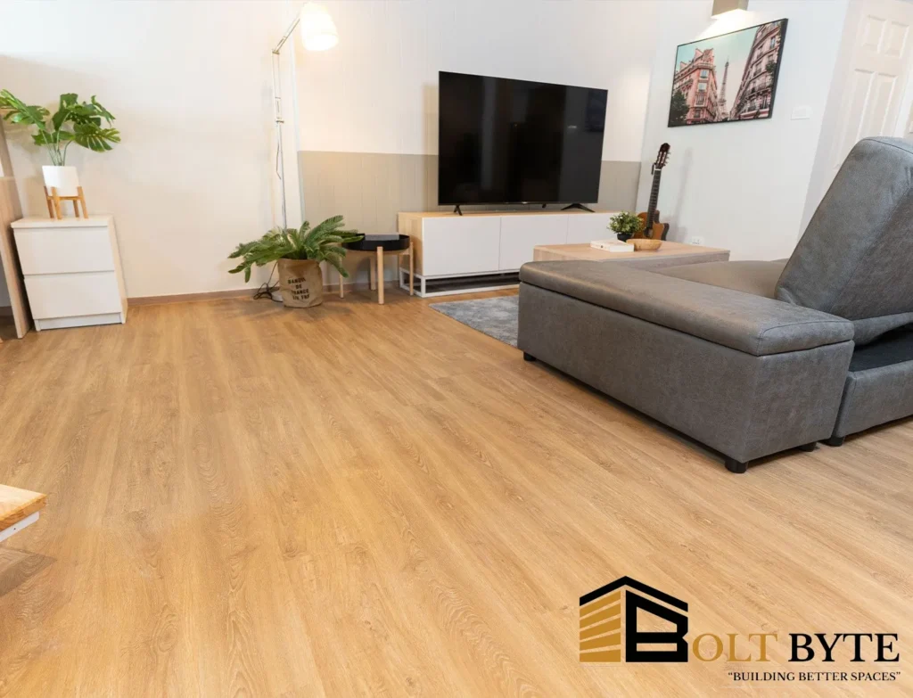 Durable and waterproof SPC flooring by Bolt Byte in a modern living room with a TV and sofa setup.