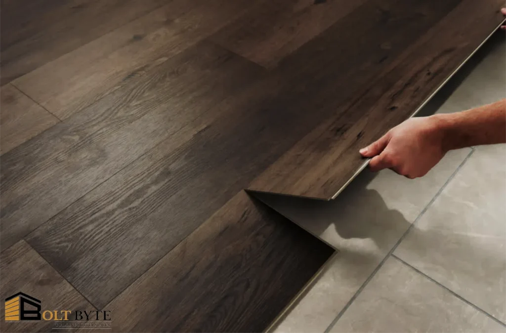 Close-up of Bolt Byte professional installing dark wood Luxury Vinyl Tile (LVT) planks over a subfloor.